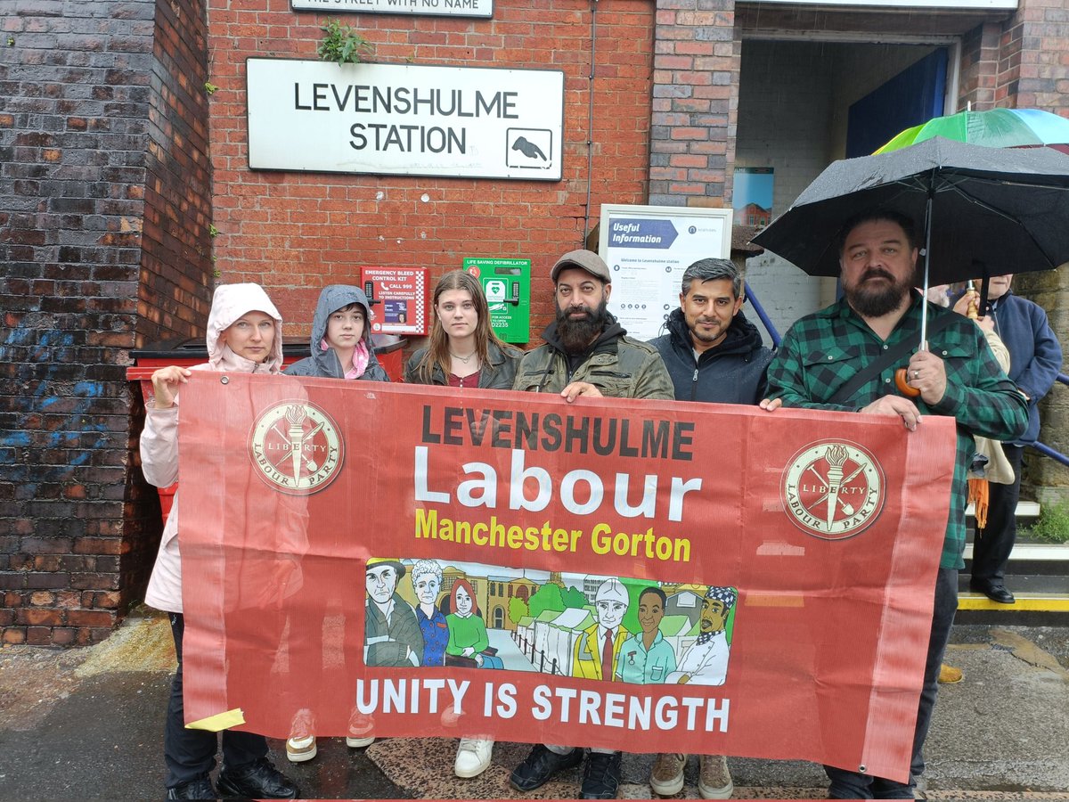 LevenshulmeLab's tweet photo. Despite the rain, Levenshulme Labour cllrs and members are out protesting the closing of our ticket office, and standing in solidarity with @RMTunion members fighting for a funded, modern railway https://t.co/i1o1WJCjCD
