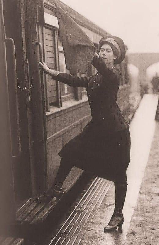 A woman guard on an electric train London, 1919.
