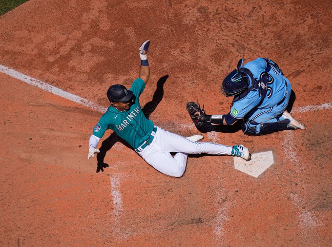 Photo of Julio Rodríguez sliding at home during today's game. 