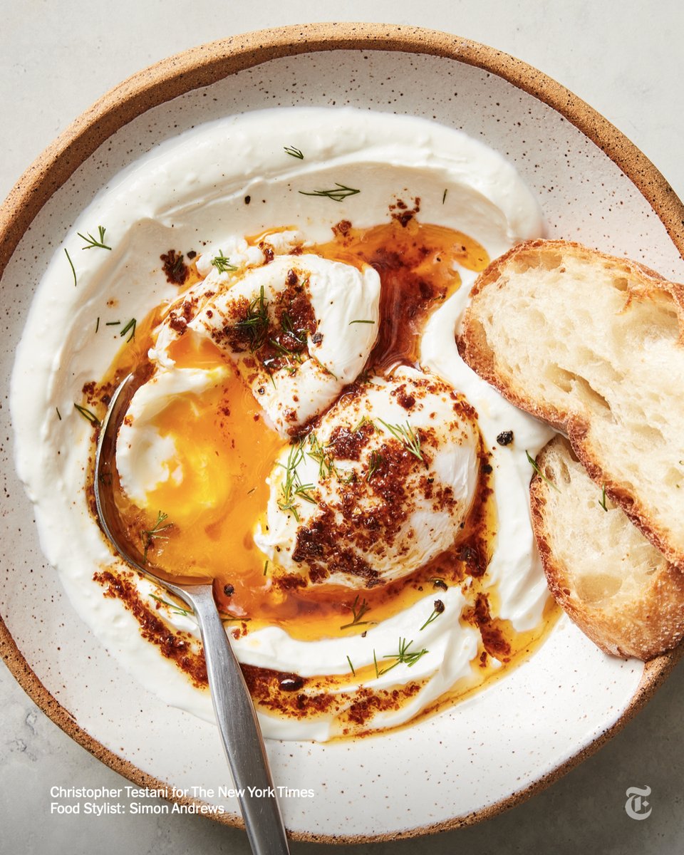 nytimes's tweet photo. This traditional Turkish egg dish of garlicky yogurt with poached eggs and a drizzle of spicy butter is rich, luscious and faintly smoky. https://t.co/xAL8KpA8cG https://t.co/GssxVLoiXg