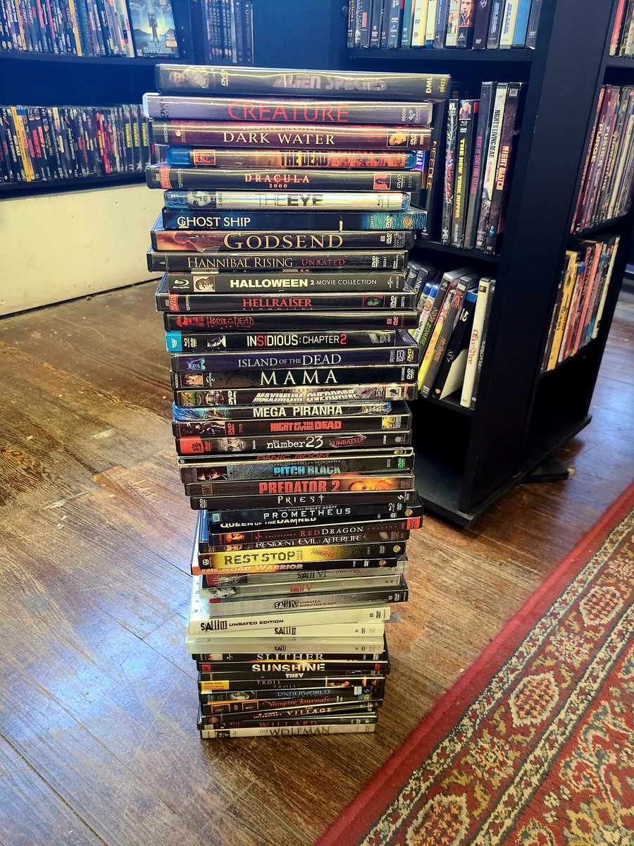 Bucketoblood's tweet photo. This tall stack of used #DVDs just hit the shelves! #horrormovies #dvdcollector #scifimovies #useddvds #moviestore #bucketoblood https://t.co/ljWqgy446F