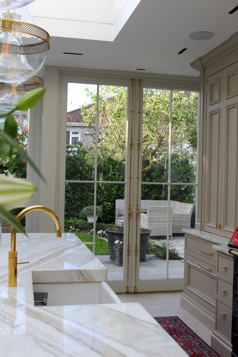 Fine glazing bars and an elegant cremone bolt complete the look in these French doors that are part of a larger garden room extension in Dublin.