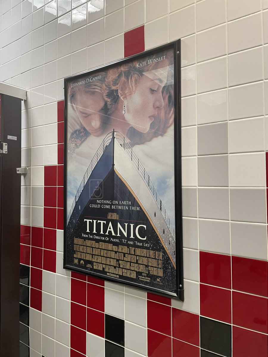 vaxtorino's tweet photo. oppenheimer showing last night was capped off by a perfect poster choice in the bathroom https://t.co/Nv1u5h0wPc