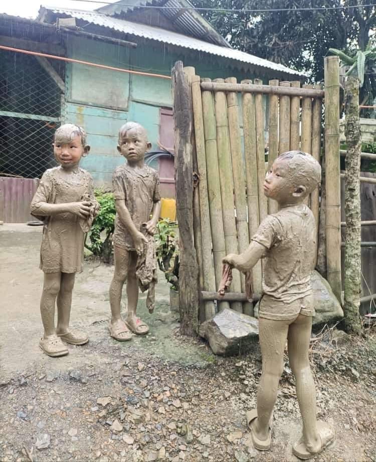 Sheepish after a mud bath on the road following heavy showers: On #FriendshipDay2023, these 3 children enjoyed life the way the little ones do. In a #Mizoram village (via WhatsApp)