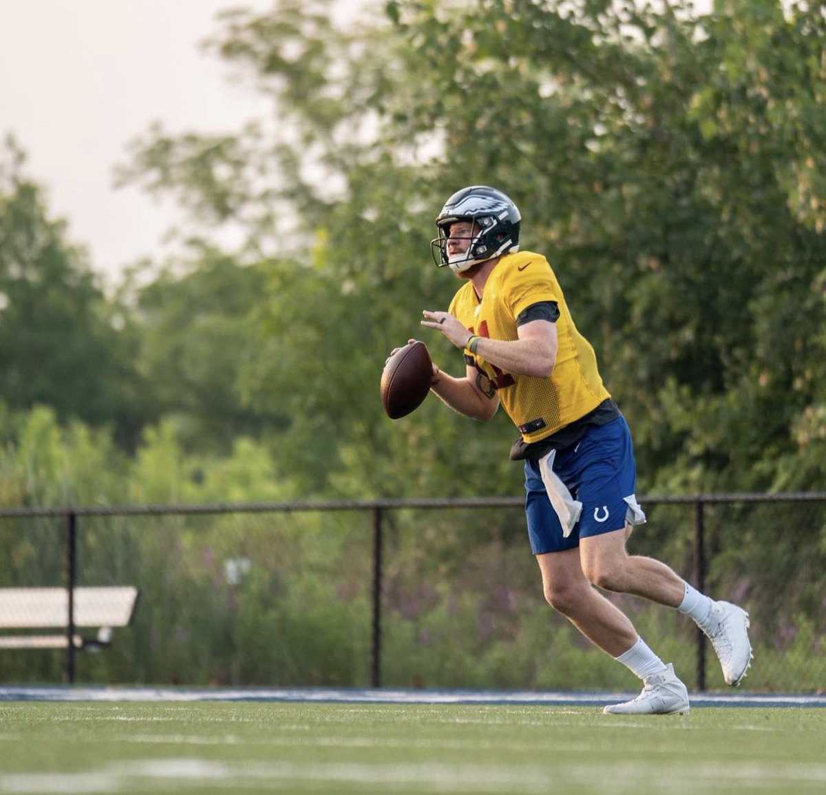 NFL_DovKleiman's tweet photo. Free-agent QB Carson Wentz shared these pictures of him training in a #Commanders jersey, #Eagles helmet, and #Colts shorts, as he's trying to get back to the league.

He captioned the post: "Back in the lab.. just looks a little different so far this year 🙃 #alternateuniforms #trainingcamp2023"