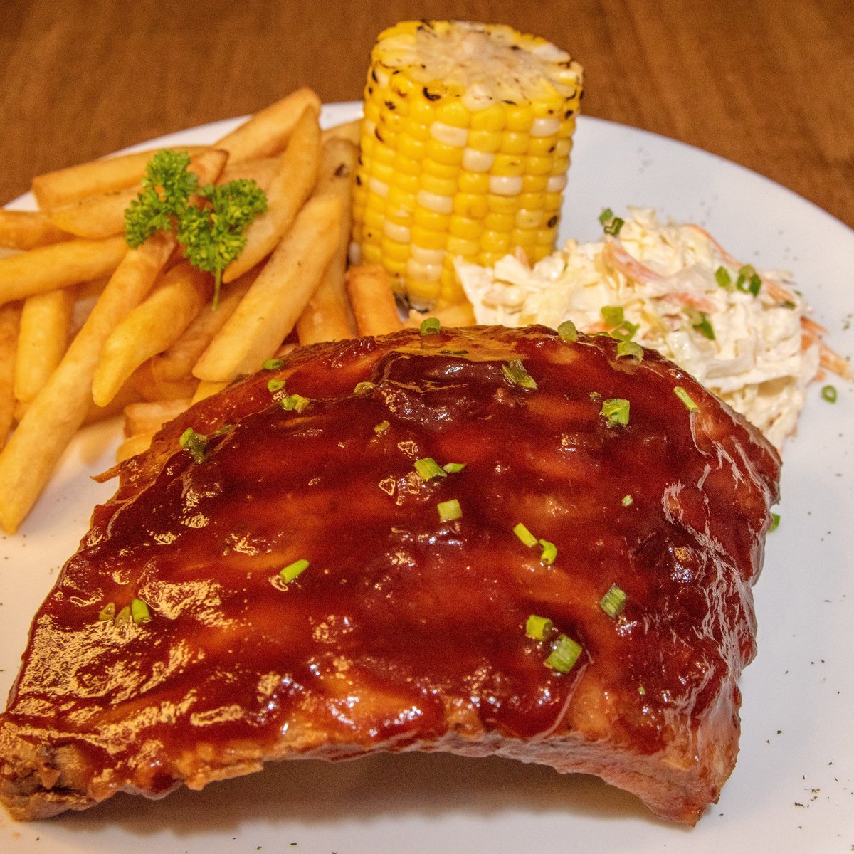 🍖 Get your hands messy and savor the smoky goodness of our tender BBQ ribs! 😋🔥 #BBQRibs #FingerLickinGood