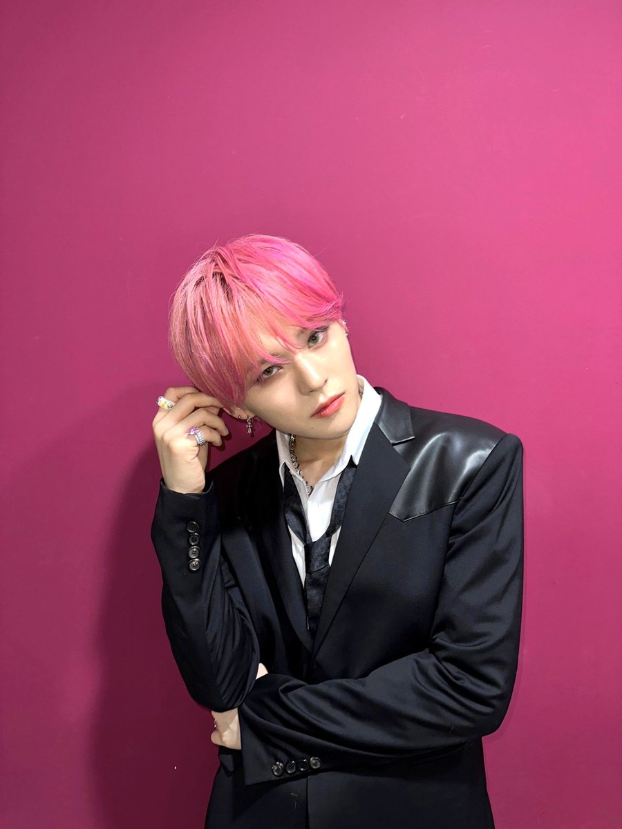 Immersed in the groove. The legend wall of Music Core and pink hair vibing in sync.