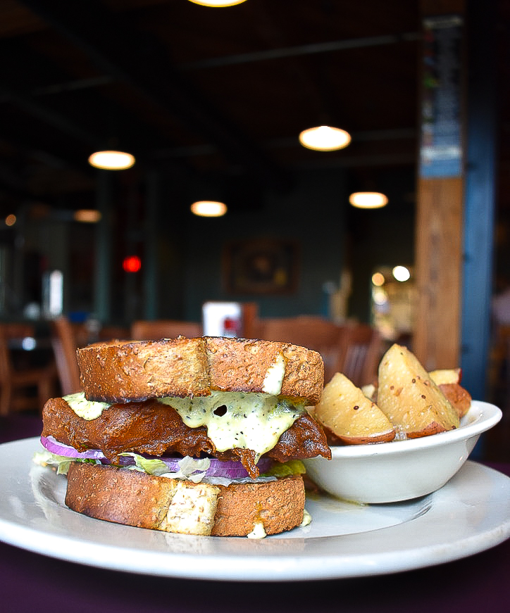 Our Fish Sandwich is a favorite for a reason. Beer-battered cod, topped with lettuce, pickle, onion, Cheddar, and tartar sauce piled high on honey wheat toast. Go ahead and ditch that sad sandwich you packed for lunch today and head on over to the Tap Room - open at 11 a.m.!