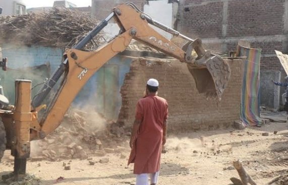 An helpless muslim man from Nuh, Haryana watching his home's demolition by government.