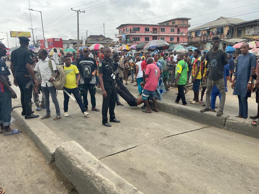 MobilePunch's tweet photo. Mob Beats Lagos Policeman Unconscious For Pushing Man Into BRT Lane

A mob beat a yet-to-be-identified policeman to a stupor after a man identified simply as Yusuf was rammed by a BRT vegicle from the impact of being allegedly pushed by policemen in the Ketu area of Lagos State.

The PUNCH gathered from eyewitnesses at the scene that the policeman and his colleagues were attempting to dispossess Yusuf of his vehicle when he got pushed into the BRT lane.

In the process, one of the BRT buses plying the lane inward Lagos rammed into Yusuf who collapsed due to the impact of the crash.

Speaking with our correspondent, an eyewitness, who does not want her name mentioned, said the policemen were responsible for Yusuf’s ordeal, adding that he sustained varying degrees of injury as a result of the incident. 

“The policemen caused this; they were the ones that were trying to dispossess the man of his vehicle and while trying to push the man out of the vehicle, they pushed him on the BRT lane and an incoming bus ran into the man,” the eyewitness said. 

Another eyewitness, whose name could not be ascertained as he hastily spoke with our correspondent when the scene got rowdy, said the policemen, after realising that Yusuf had been crushed by the BRT, attempted to flee the scene but an angry mob apprehended one of them. 

He said, “It was people that beat the policeman till he fainted. He has not died because I still observed that he was breathing. People were annoyed about what they did to that man. 

“The man sustained serious injuries, look at him lying unconscious on the floor and his blood on the road.”

Credit: Deji Lambo
---
Follow us for more breaking news and videos