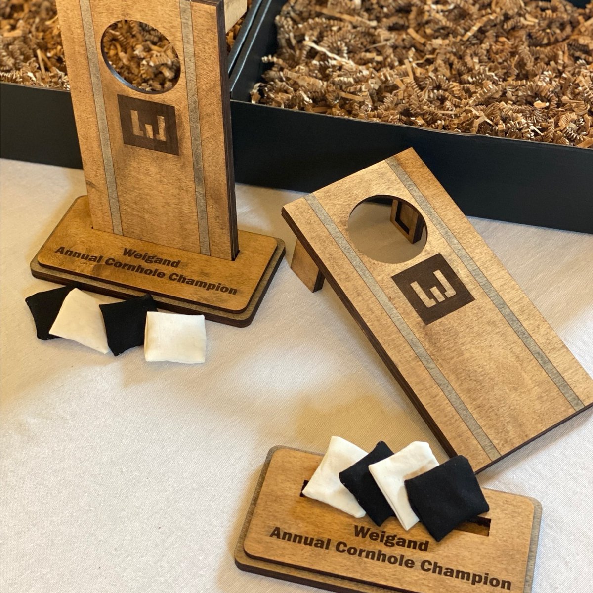 yourpromopeople's tweet image. We recently had these custom cornhole trophies made for  @WeigandConstr's annual cornhole tournament. Instead of just having them function as a trophy though, we made them functional to use as a tabletop cornhole game!