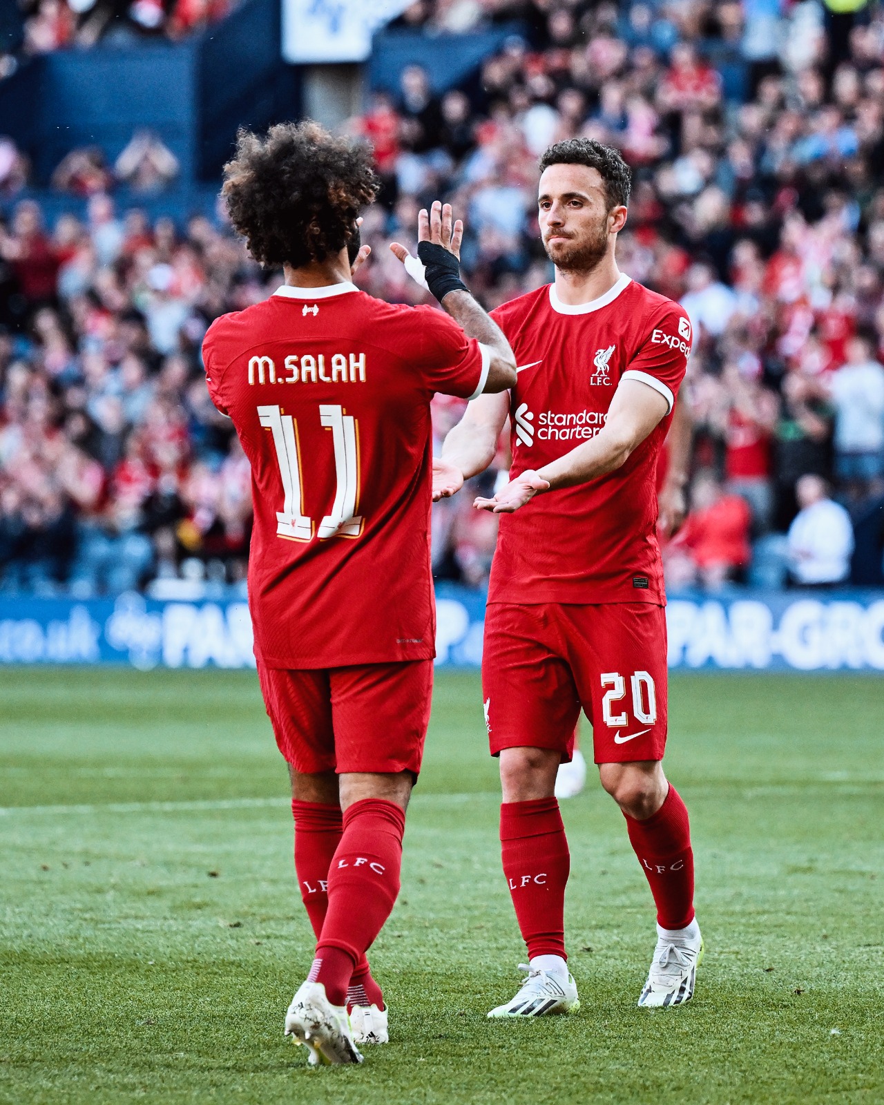 Mo Salah and Diogo Jota celebrate after both scored early on at Deepdale against SV Darmstadt 98. 