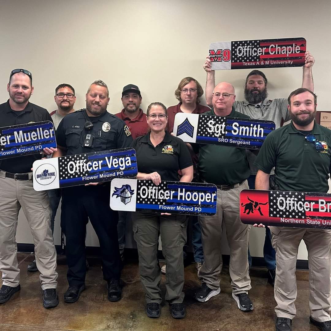 FlowerMoundPD's tweet photo. Our School Resource Officers received an awesome surprise when the Town's Traffic Division (Signs and Markings) showed up with custom "road" signs for their individual offices! Thanks for helping to "class" up their spaces a little bit! https://t.co/FNc3zKomx1