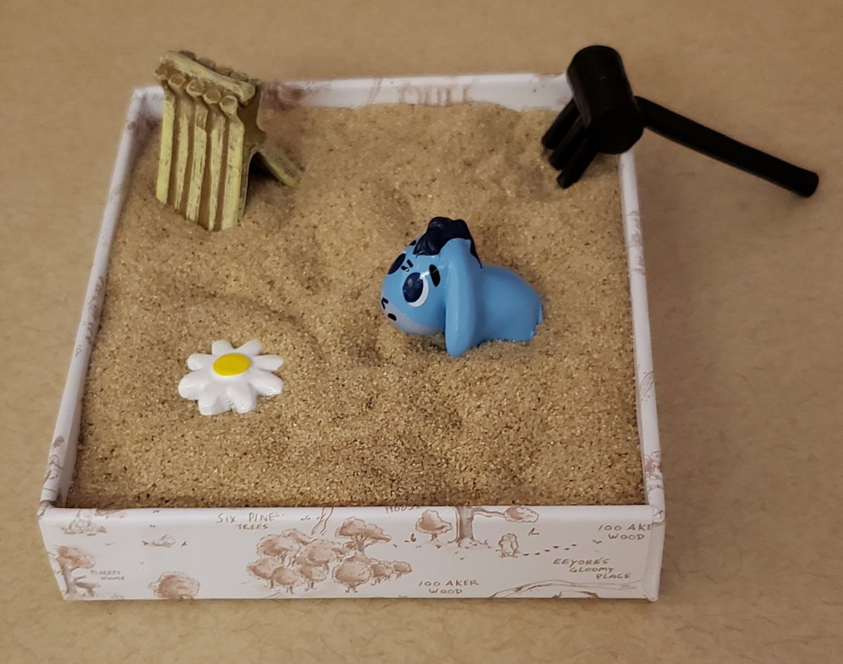 brianne1017's tweet photo. This is my new Eeyore Sand Garden. I'm putting it on my desk at work. Let's see how long it takes before it gets stolen, broken, or destroyed. #ThanksForNoticingMe https://t.co/nqnoStinMX