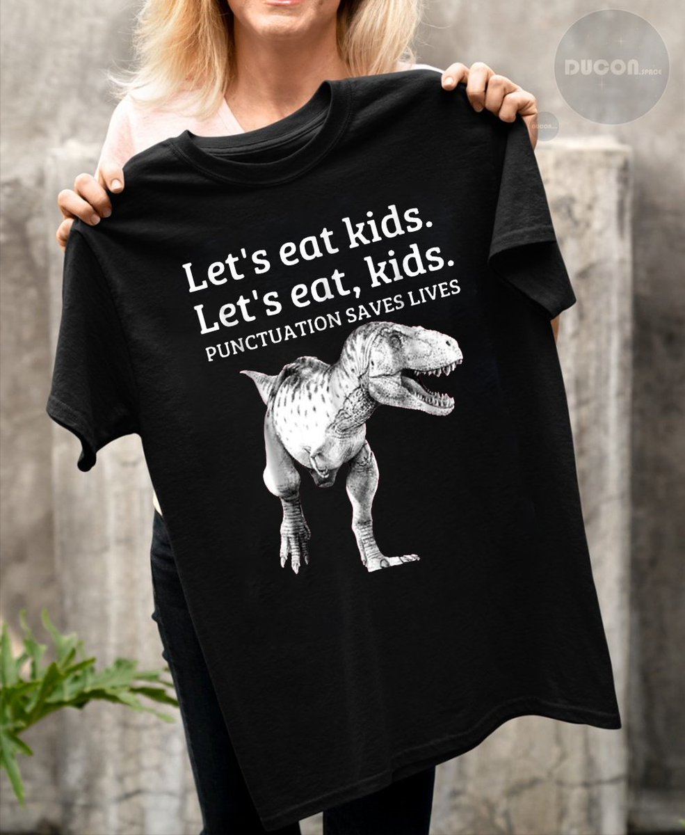 Add a touch of wit to your wardrobe with our comical T-shirt - 'Let's Eat, Kids! Punctuation Saves Lives, Grammar' - a fun reminder of the importance of language precision! 😄👕 #FunnyTees #GrammarNerd #LanguageHumor ducon.space/comical-let-s-…