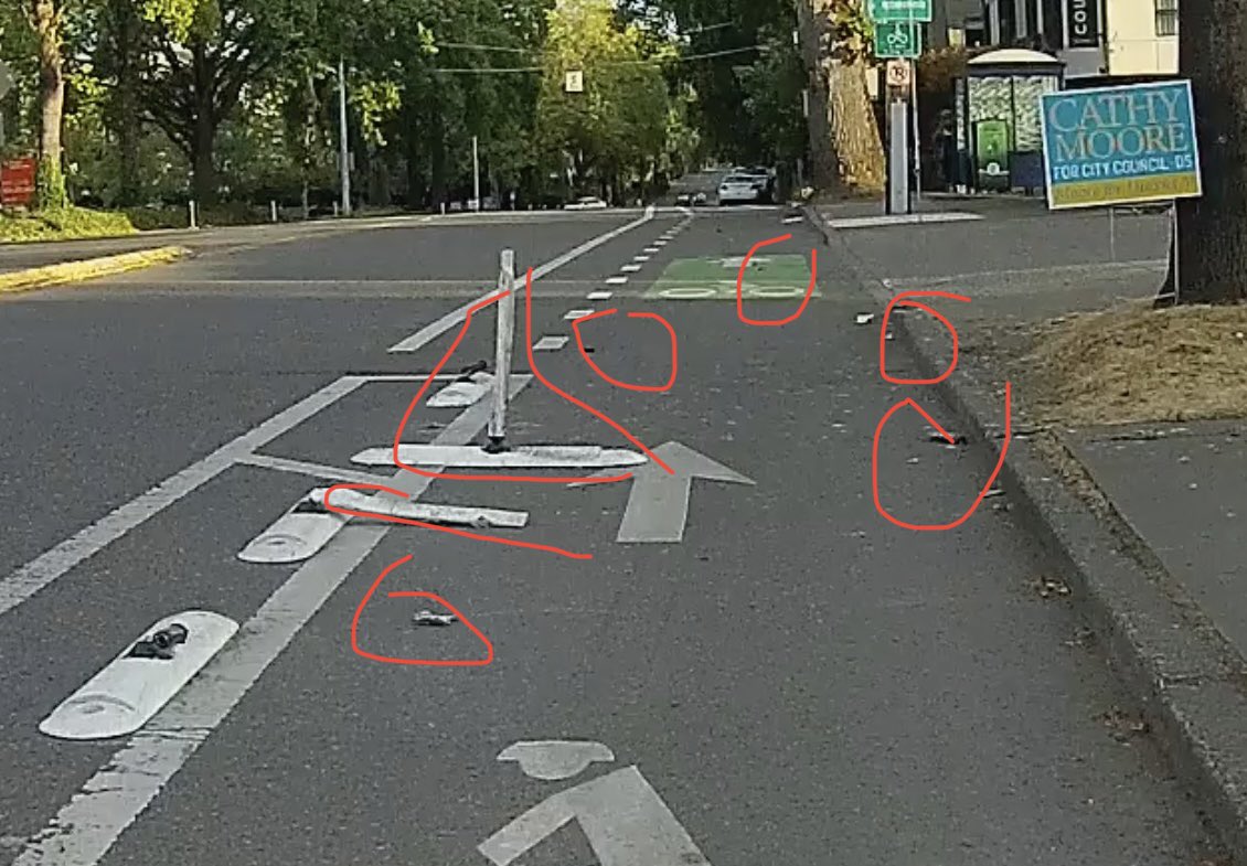 SeattleBikeDad's tweet photo. Freshly destructed flex posts with plastics and metal debris on the road (Meridian Ave N and N Northgate Way). https://t.co/8gq60r2mSI