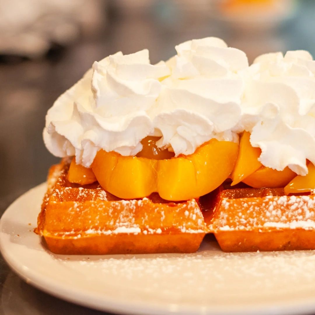Craving a classic? Our fresh waffles topped with peaches are sure to satisfy. Check out our full menu on our website and come visit us at More Than Waffles!