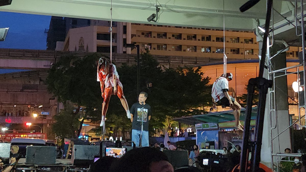 MayWongST's tweet photo. #Thailand protesters downtown #Bangkok dousing themselves with red paint & hanging themselves up to remember those who died here at #Ratchaprasong during earlier violent days of 2010 protests. They say they've been fighting for democracy till today #respectmyvote #ม็อบ27กรกฎา66 https://t.co/7O4IiSXqlm