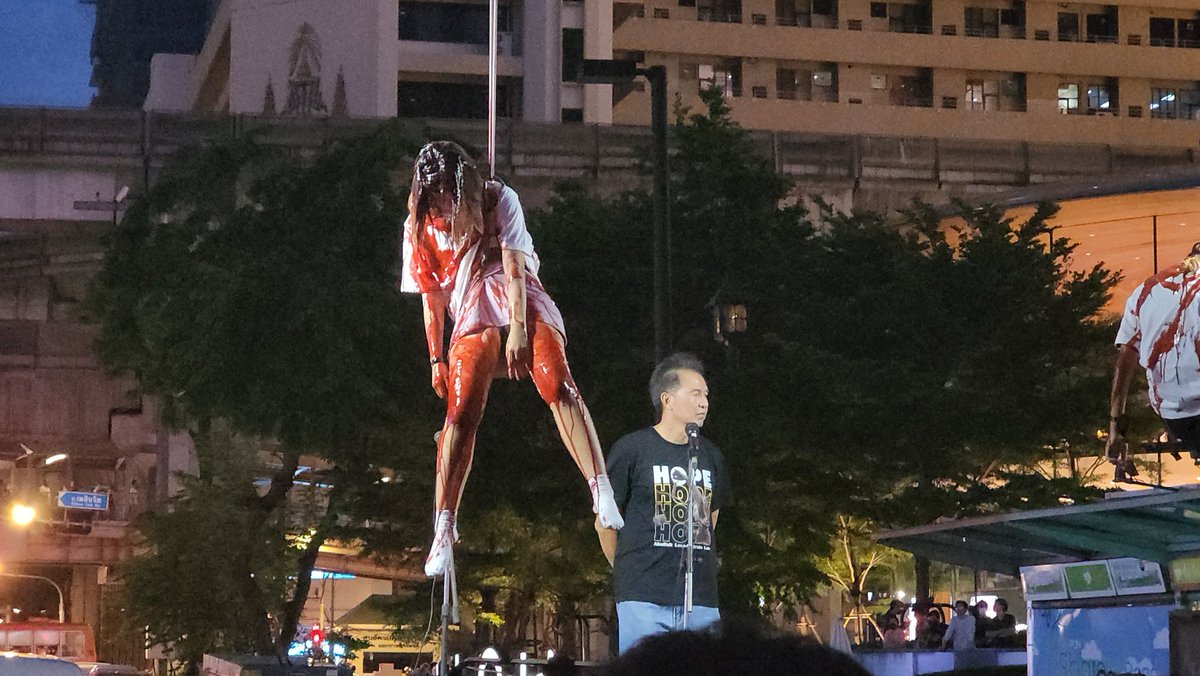 MayWongST's tweet photo. #Thailand protesters downtown #Bangkok dousing themselves with red paint & hanging themselves up to remember those who died here at #Ratchaprasong during earlier violent days of 2010 protests. They say they've been fighting for democracy till today #respectmyvote #ม็อบ27กรกฎา66 https://t.co/7O4IiSXqlm