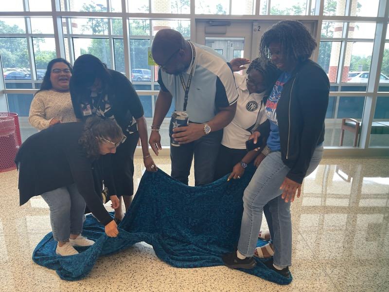 AldineHistory's tweet photo. Social Studies challenge of the day. Can your group flip the tarp over without stepping off the tarp? https://t.co/yA7Xis64y5