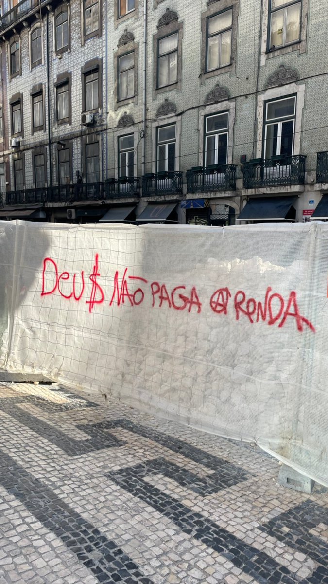 "God doesn't pay the rent"    
Graffiti in Porto for the pope's official visit to Portugal