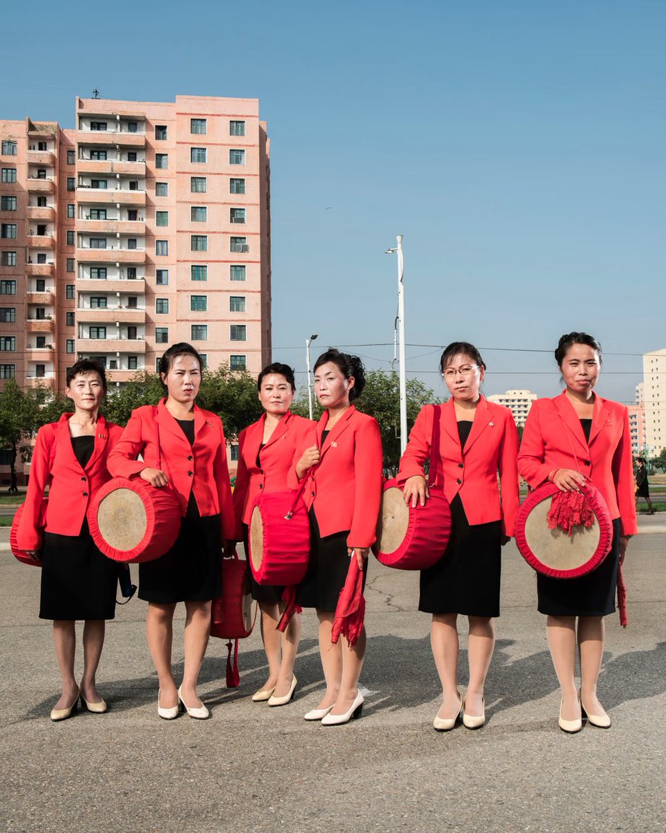 Pyongyang, 2017. A group of musicians in front of the Monument to Party Founding. Many dance and music rehearsals are done in the street to motivate walkers. North Korea by Stephan Gladieu 🇰🇵