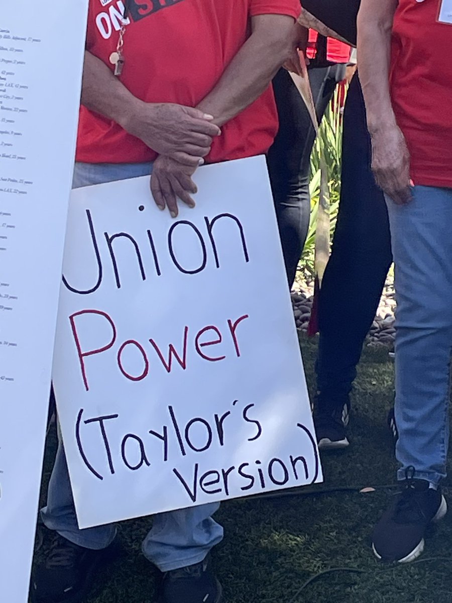 suhaunah's tweet photo. striking hotel workers are urging @taylorswift13 to postpone her LA concerts next week. here are some signs from their protest outside the Hyatt Regency LAX this morning: https://t.co/DRKI8zAbUQ