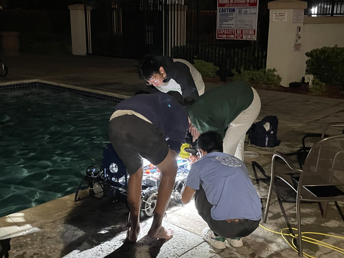 AVBotz's tweet photo. Day 53: Night Testing...

Photo 1: The bat signal is up! Isabelle shines the light on Marlin as Aarav watches Marlin approach the torp board.  

Photo 2: Members gather around Marlin to check on torpedos.  

Photo 3: Craig and Isabelle check on thrusters

See you tomorrow! https://t.co/gGSbvMPK6S