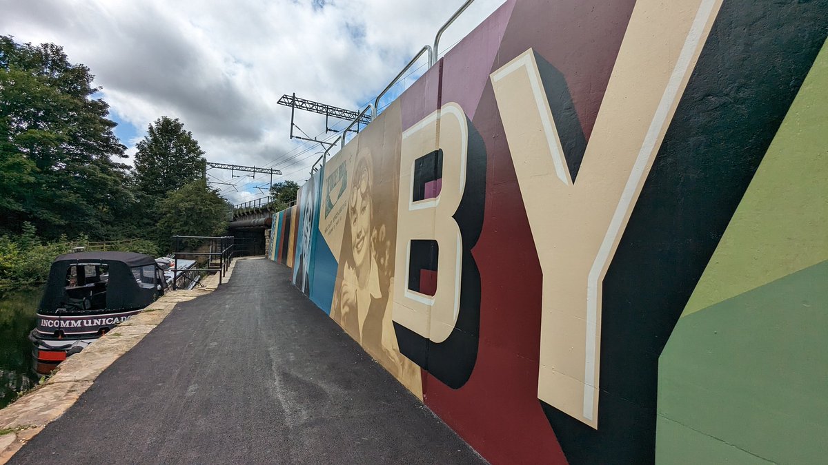 helenkellar's tweet photo. @Sustrans route 67 Rotherham is open! Amazing work @RMBCPress @JacksonCivils building flood defences between live rail and the canal. Solid concrete wall has been adorned with a colourful mural. 8 miles  mostly traffic free or segregated route from #Sheffield to #Rotherham 🚴🎉 https://t.co/MWZy03lkqB