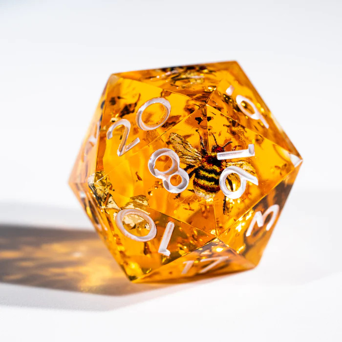 🎁GIVEAWAY ALERT!🎊
Buzzzz!🐝 We've created this bee dice.🎲
These honey-hued cuties have etched bees ready to bring some sweetness to game!
The translucentgolden resin glitters like a 🍯. Follow and RT to enter to win a set of our honeybee dice with buzzing details! 
To enter: