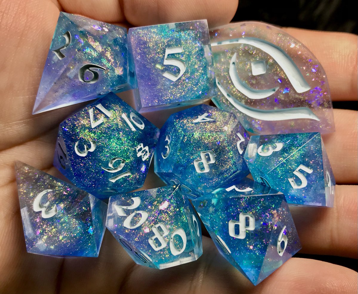 Want this 9-piece set of artisanal #dice? 👀 I'm happy to announce a #GIVEAWAY 🎉 Enter to win this #handmade dice set 💎 Shimmering azure blue, based on primordial sea goddess, Hura. 🌊 To enter: - Follow this account! 💜 - Like and retweet this post! #Winner chosen 8/2⚔️