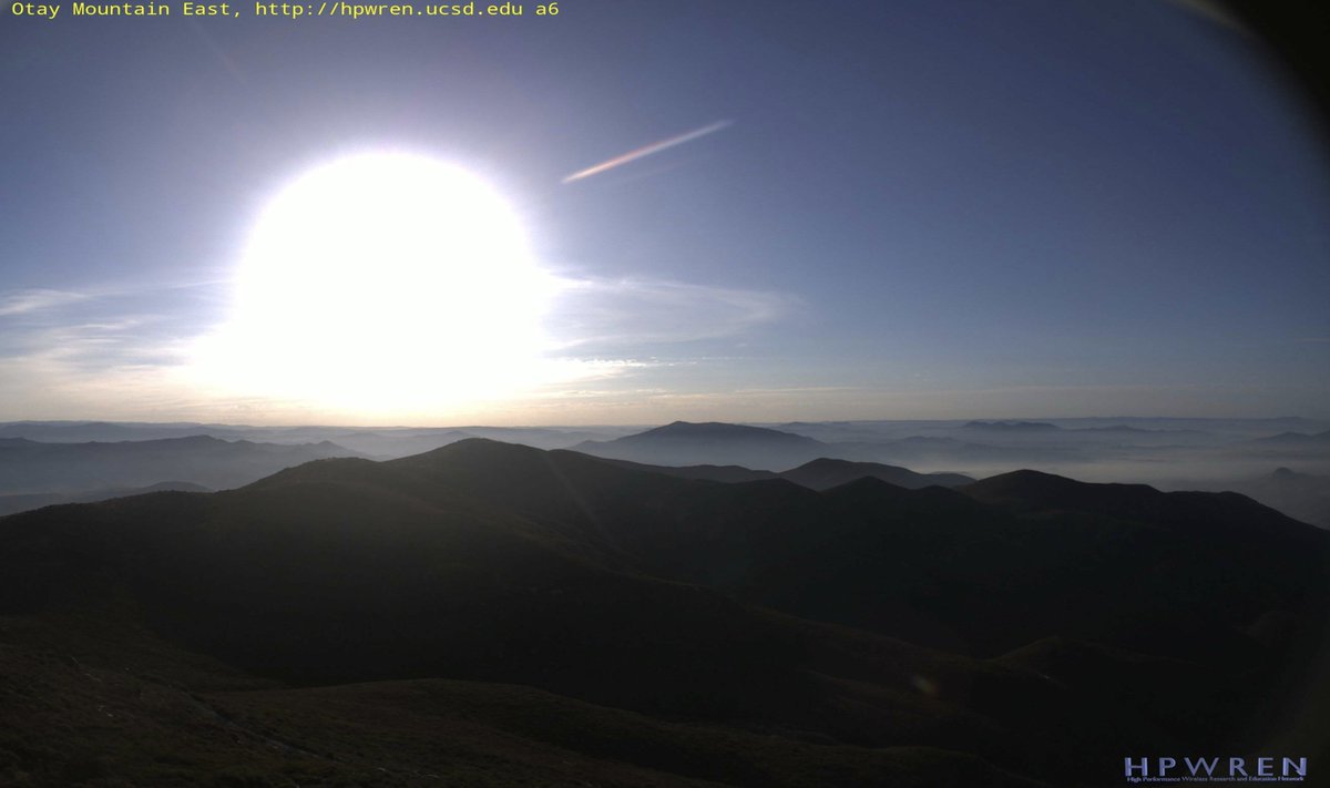 ericfrost's tweet photo. #SDSU watching the #Border20Fire & others near US-Mexico border by #Tecate on #WIFIRE https://t.co/9hskT380xk on Friday morn at 7:20am. Wind very light, almost no wind. #HPWREN Otay Mtn. East camera shows smoke in valleys as sun rises. https://t.co/mkeEIknsbx