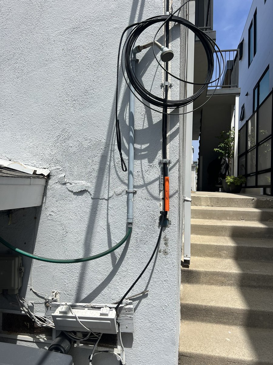 KrisTinsley's tweet photo. @SCE Noticed this re-wiring hack job done by your linemen on our property. Excess wiring wrapped around the outdoor shower…really?! Completely unsafe &amp; a job we did not request or authorize. I’ve called &amp; reported this, but cannot believe your employees lack of consideration. https://t.co/orAJRtA3ps