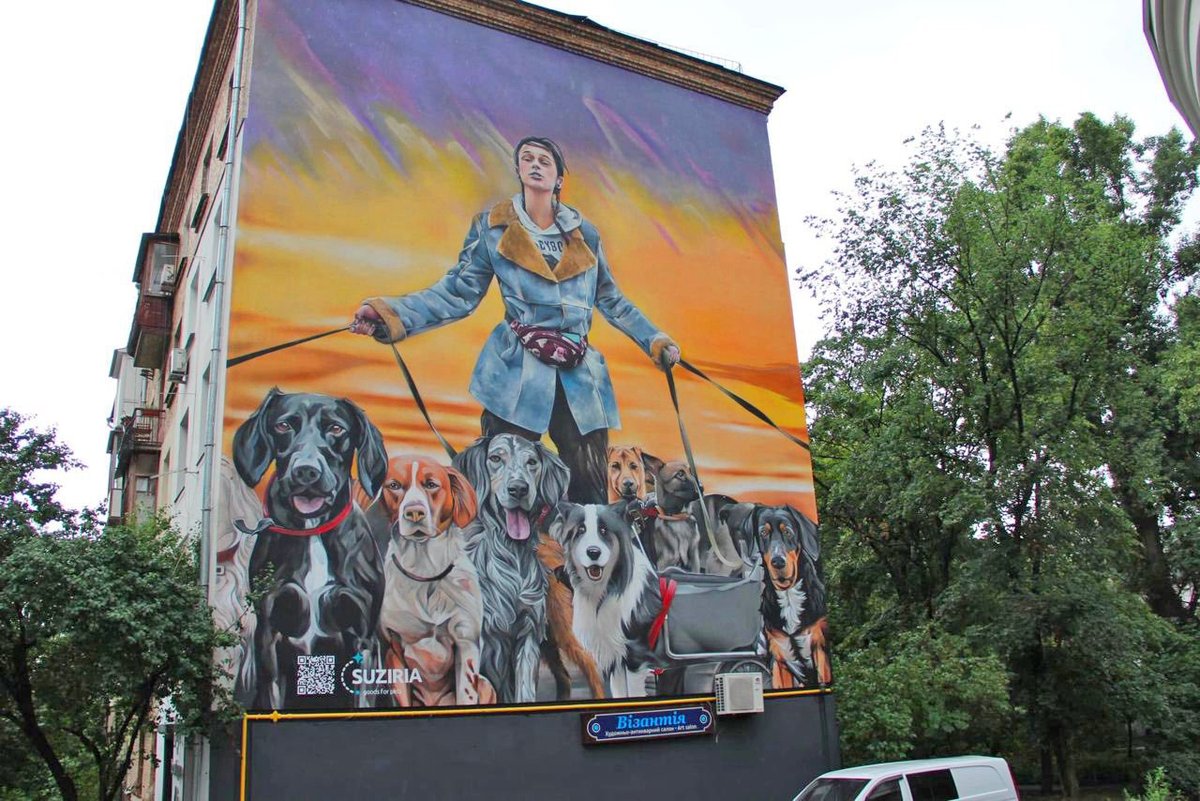 LorenzoTheCat's tweet photo. New street mural in Kyiv, Ukraine honoring Anastasia Tykha, the volunteer who bravely escorted disabled dogs out of Irpin when the war began. https://t.co/mEzBqhBDlA