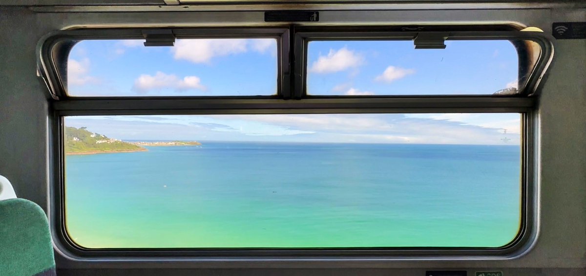 MrTimDunn's tweet photo. This morning I pootled along the St Ives branchline, hugging bay by clifftop. The Caribbean blue of sea I’ve not enhanced; nor the golden sand. It is a line I’ve been on often, but the noses pressed to glass and exclamations of delight never fail to bring me joy. #travelbytrain. https://t.co/hYGxbQG6Ug