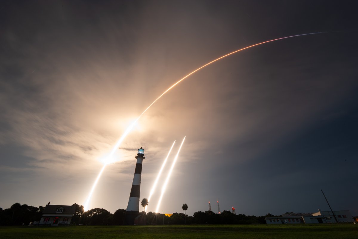 Rebbierc's tweet photo. The third time WAS a charm. A beautiful launch tonight for the @SpaceX Falcon Heavy rocket carrying Hughes satellites from pad 39A. This is a single exposure of the launch from the Cape Canaveral Lighthouse, and then the two side boosters landing 7.5 minutes later at LZ-1 &amp; LZ-2. https://t.co/m8KauQzTsm