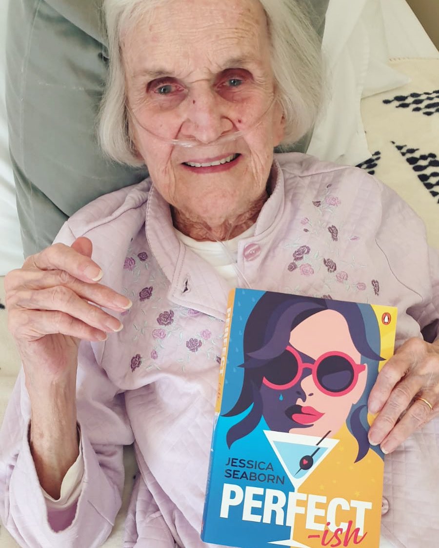 After years of telling me that she hopes she’s still alive to see me publish a novel my 91yo grandma got to hold a final copy of PERFECT-ISH today 😭 Apparently she’s been telling everyone in the nursing home about my book. Excuse me while I BAWL like a BABY #WritingCommunity