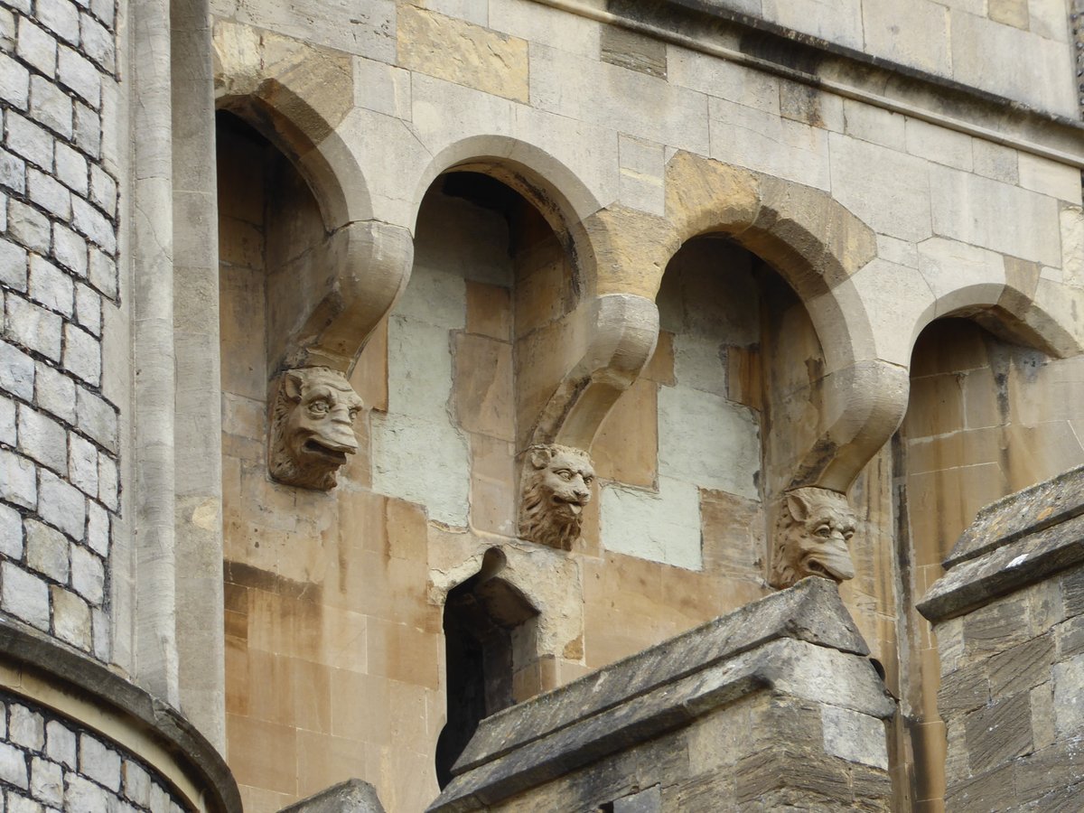 He's just a shy lion, and only wants to stick his tongue out just a little bit.  #Caturday at Windsor Castle.  @Pericles494BC 

Machicolations (I think is the correct term) supported here by some curious faces, right and left.