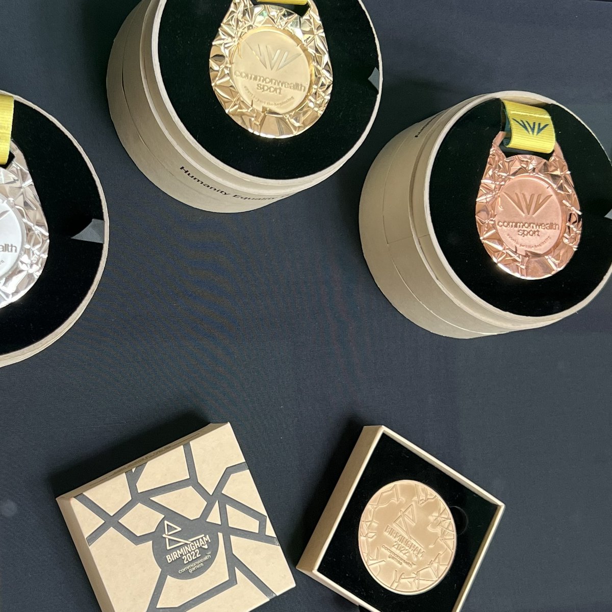 BhamFestival23's tweet photo. Making your own medal at The Exchange, @unibirmingham. Open throughout the festival and FREE! Also check out the official @birminghamcg22 baton and medal display. #BirminghamFestival23 https://t.co/iYLP51bbvd