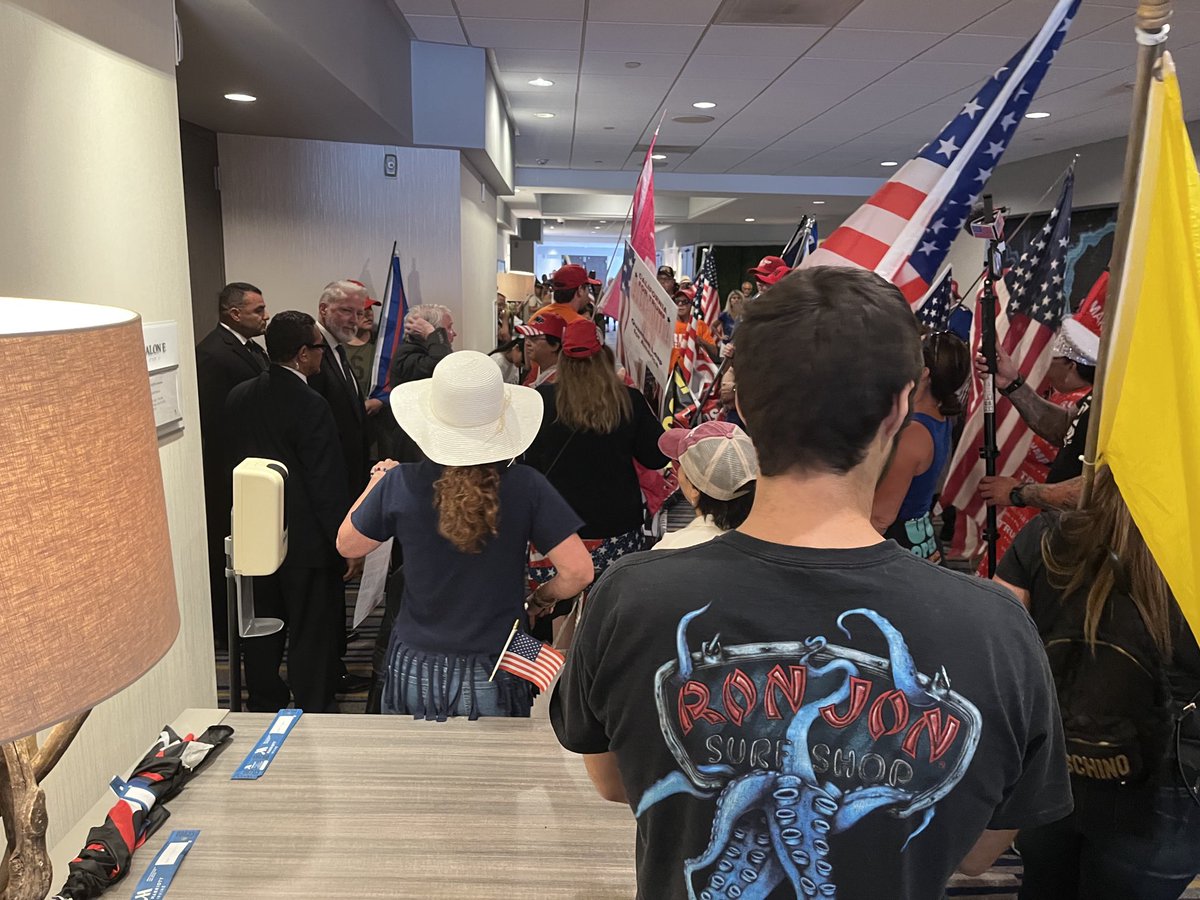 LATSeema's tweet photo. They’re trying to get into the meeting and security is blocking them. ⁦@CAGOP⁩ https://t.co/KtcMVMGp41