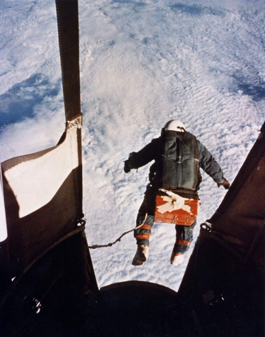 Man jumping out of a capsule above the clouds.