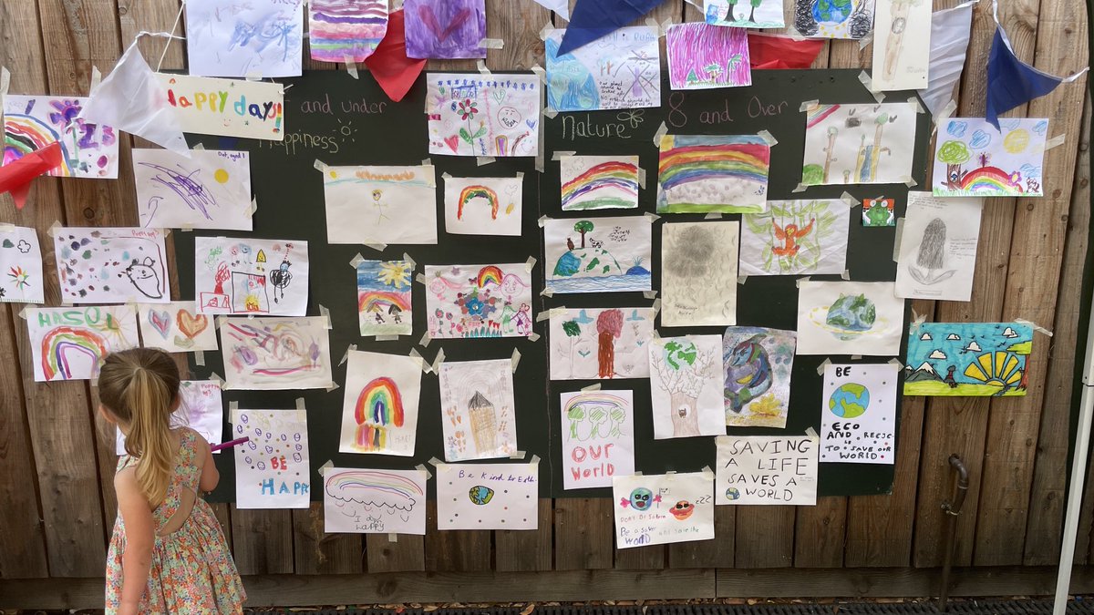Love this from our summer party today - a young artist spots her entry displayed on the wall of our art competition 😊❤️