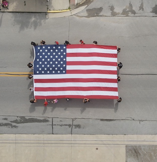 PH_FOOTBALL_PH's tweet photo. Prairie Heights athletes representing their families, school, and teams, carrying the American flag in the Orland Vermont Settlement parade! They followed the American Legion Post 423 color guard today! Big thanks to the Legion members who do all they do for our community! https://t.co/1oMr7K1hxx