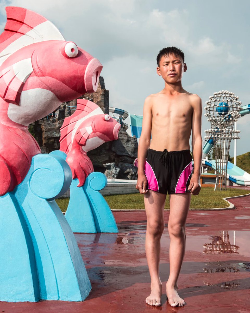 Pyongyang, 2018. A young boy poses at the Munsu Water Park North Korea by Stephan Gladieu 🇰🇵