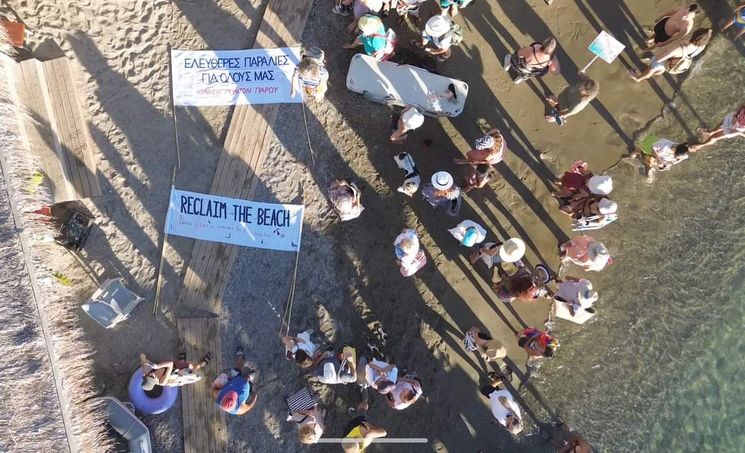 A movement has been born in Paros. It's motto is "Reclaim the Beach", and it's formed up by residents of the island who protest in front of greedy beach bars, demanding access to the beach for all as well as an end to illegal sunbeds. Here they are in front of Marcello Beach.