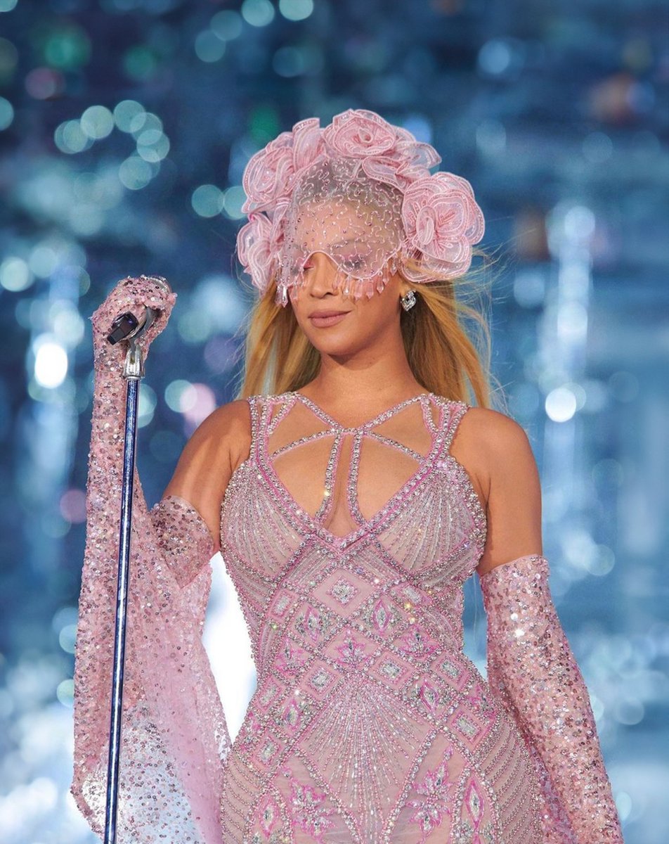 Beyonce stuns in Georges Hobeika at her Renaissance World Tour, wearing an  enchanting pink tulle dress adorned with shimmering crystals. The  captivating flair is complemented by tulle gloves and draping shawls, with
