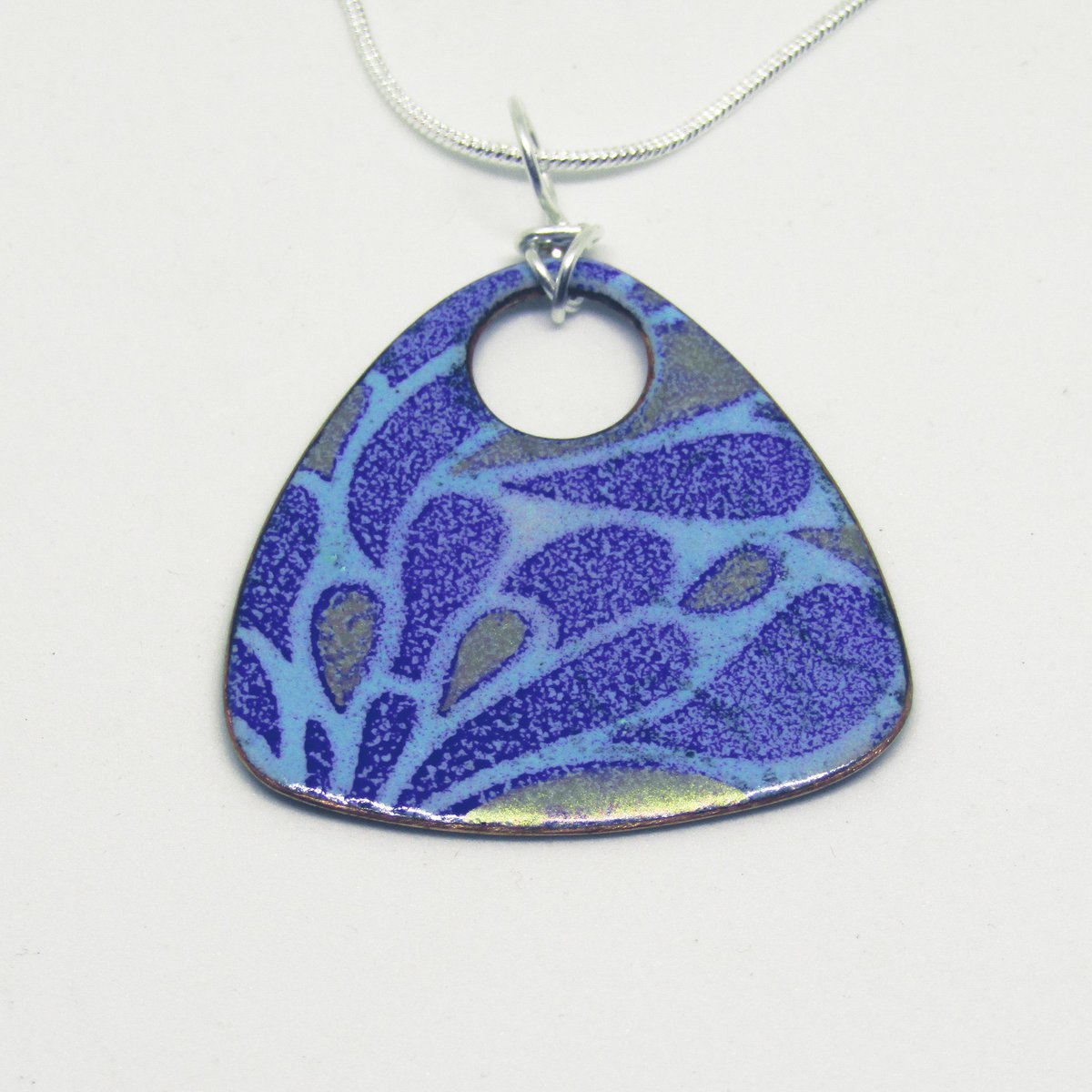 Splash Pendant Necklace by Anne McArdle is a blue triangular pendant necklace with splash pattern and gold mica highlights. Sterling silver chain. # #sterlingsilver #jewelleryartist #contemporaryjewellry #necklace #bluejewellery #copper #enamel #kentgallery #enameljewelry #blue