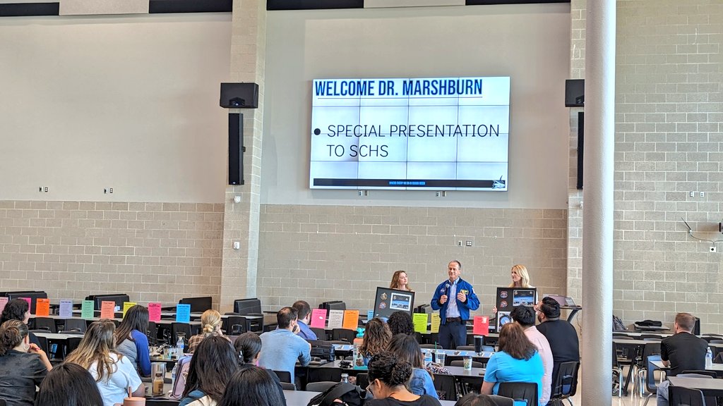 ShadowCreekHS's tweet image. Tom Marshburn, his wife and daughter Grace, a SCHS Band alumna, make a surprise visit to present Mr. Mooney and our SCHS Band with a framed copy of the SCHS Band sticker that was flown aboard the International Space Station during expedition 66 &amp;amp; 67.