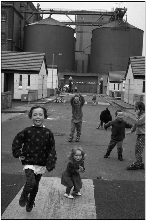 YourWullie's tweet photo. When kids ruled the streets 
.
Kids playing in front of the Guinness brewery, Dublin, mid 1990s. 
Photo Martine Franck https://t.co/NP8HqZL18f