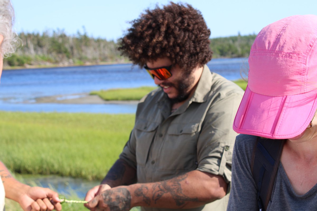 nsccforests's tweet photo. Zachary Scantland-Griffiths, a recent NRET grad, working with sweetgrass under the guidance of Elder Tuma Young and UINR Earth Keepers in Unama'ki (Cape Breton) last week. Love seeing students wearing those Silver Rings proudly out in the field! @CIF_IFC https://t.co/KmsUWMXq9P